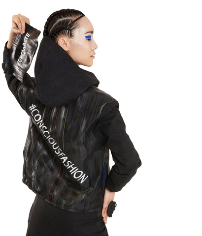 A woman wearing a biker jacket made from up-cycled bike tube by Malaika New York