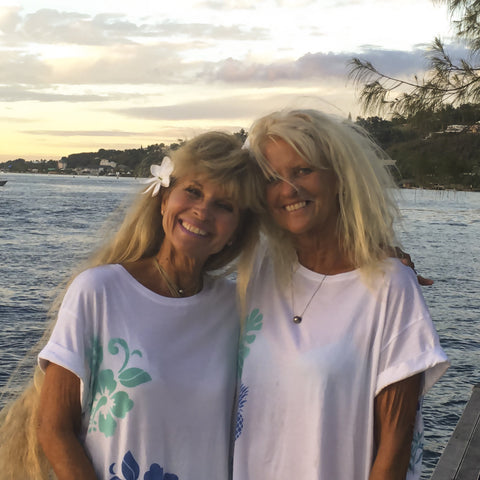 Coolies Surf founder Patti (right) with sister, enjoying a favorite sunset viewing sport.