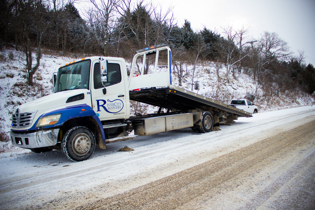 River City Recovery Rollback pulling a truck out of the ditch.