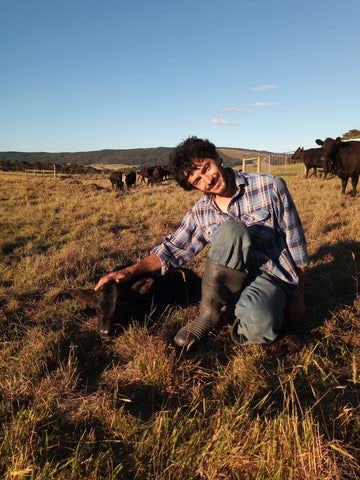 Alex in the paddock with a day old calf