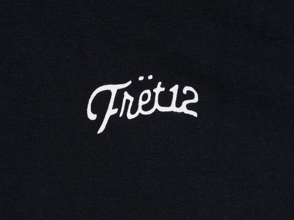 Closeup of FRET12 script logo on left chest. 