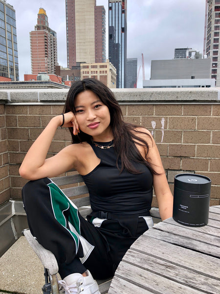 sally kim sitting on rooftop wearing madison mckinley jewels