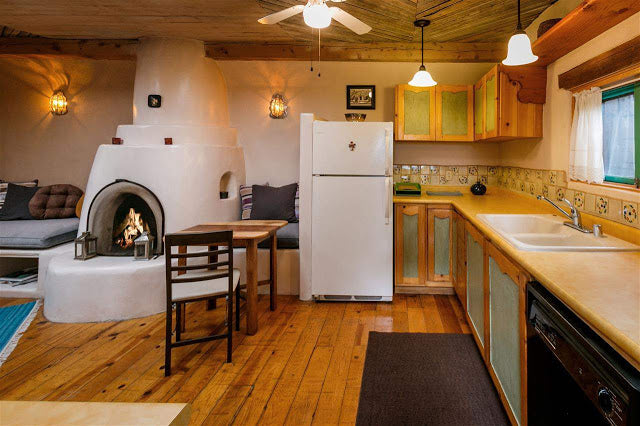 Santa Fe Pueblo Style Tiny Home Interior - Kitchen and Kiva Fireplace