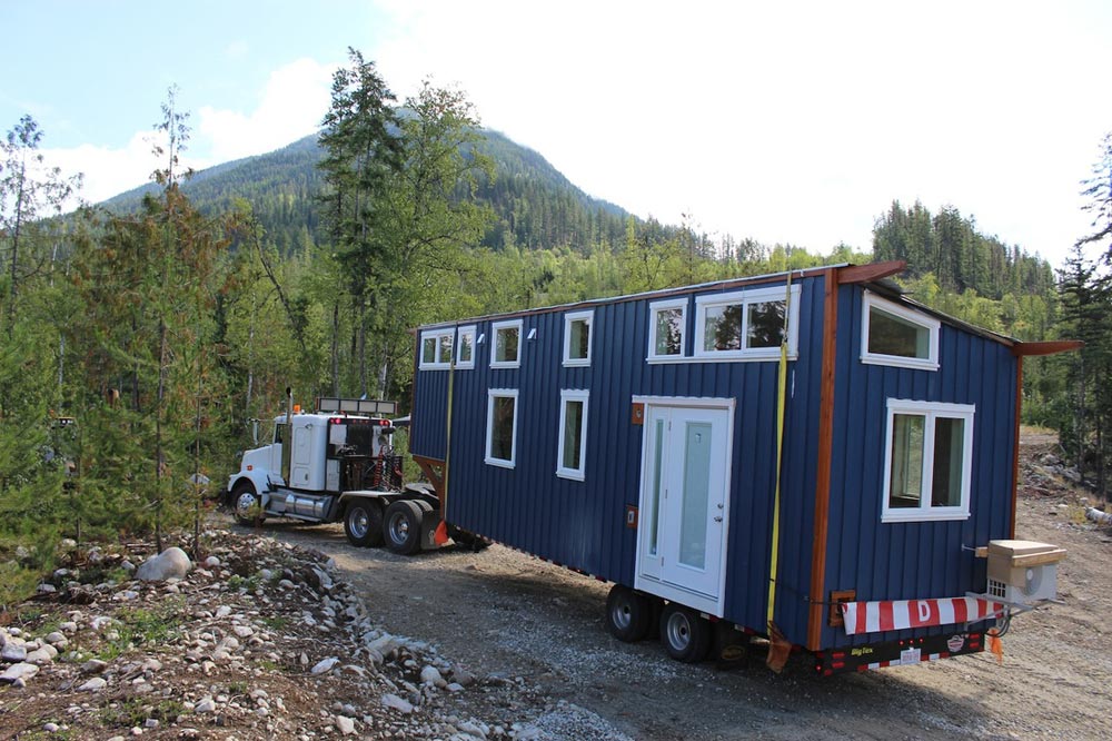 This 38' gooseneck tiny house on wheels is built by Nelson Tiny Houses based in Nelson, British Columbia, Canada!  This huge tiny house features 380-sqft of floor space (including the gooseneck bedroom) and includes a very open floor plan. Inside, you'll find a multi-functional living/dining/work space upon entering the home, a huge kitchen with countertops and cabinets on opposite sides of the house, a mid-size bathroom with a toilet and shower, a bedroom on the gooseneck, and an additional loft above the living room that adds extra sleeping or storage space!  Follow Nelson Tiny Houses on Instagram or contact them here for any questions!  The “Winter Wonderland”—A 38’ Gooseneck Tiny House built by Nelson Tiny Houses  The “Winter Wonderland”—A 38’ Gooseneck Tiny House built by Nelson Tiny Houses  The “Winter Wonderland”—A 38’ Gooseneck Tiny House built by Nelson Tiny Houses