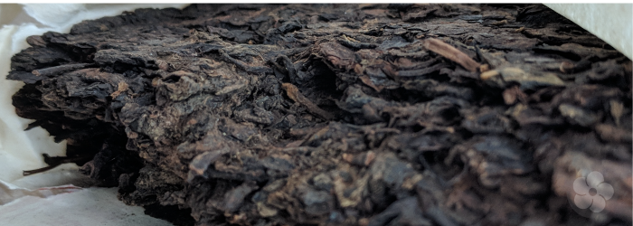 traditional sheng pu-erh tea, usually compressed into discs or cakes, has less caffeine thanks to long term aging.