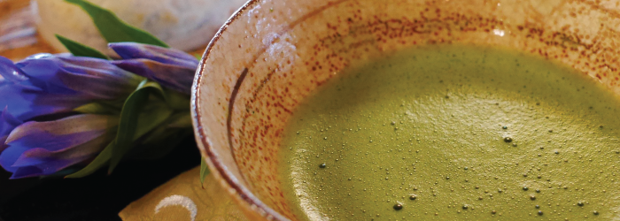 traditional matcha whisked into a frothy beverage