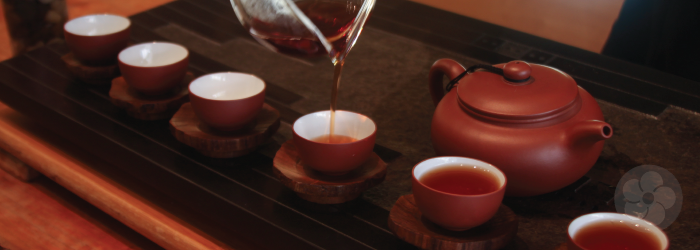 teacups with trivets in gong fu cha service with yixing teapot