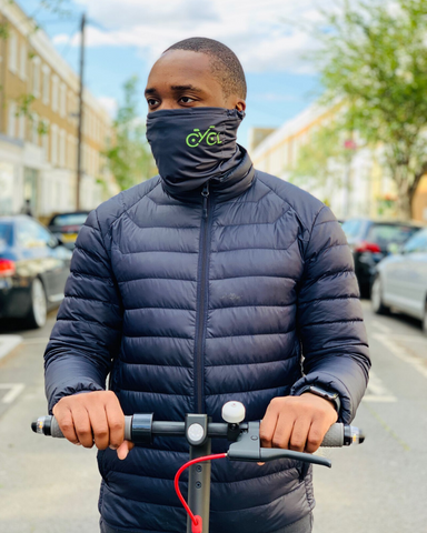 Man on e-scooter wearing pollution mask