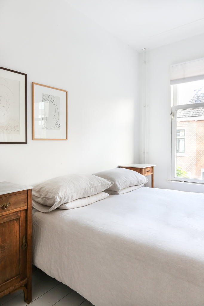 Plain bed with beige linen bedding