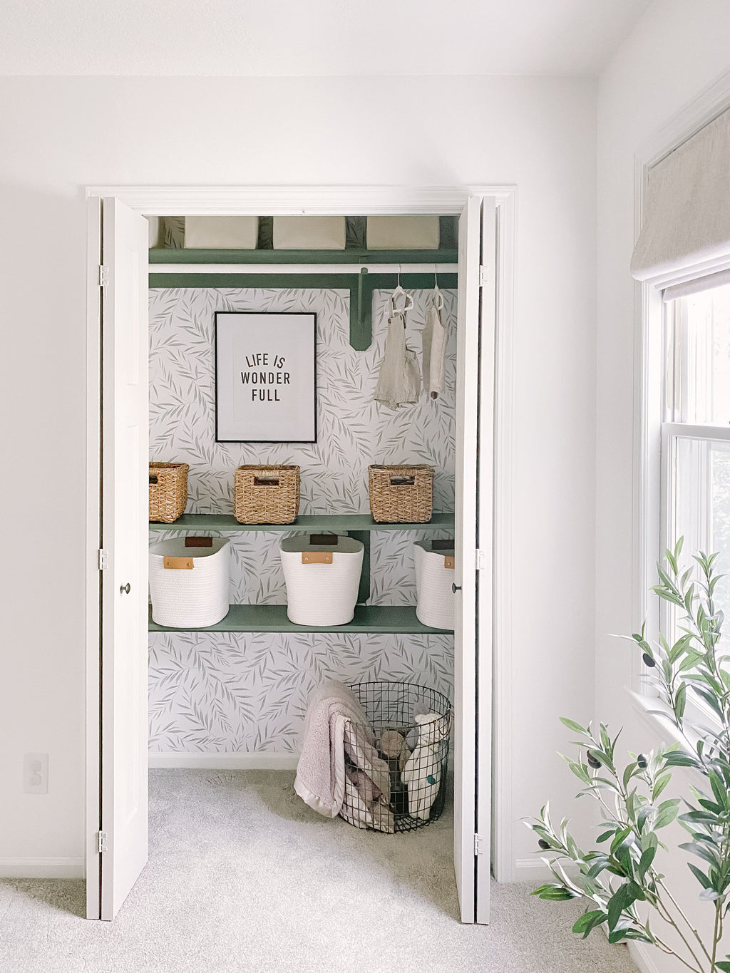 Nursery closet organisation ideas, boho gender neutral nursery closet design with removable wallpaper