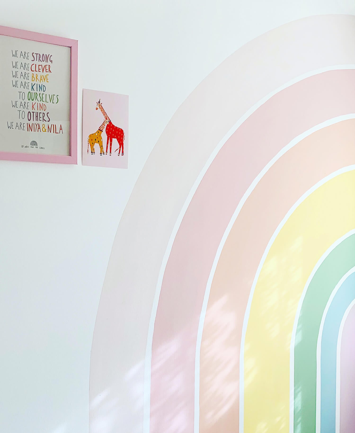 Modern diy rainbow wall mural in pastel colored shared girl's room interior