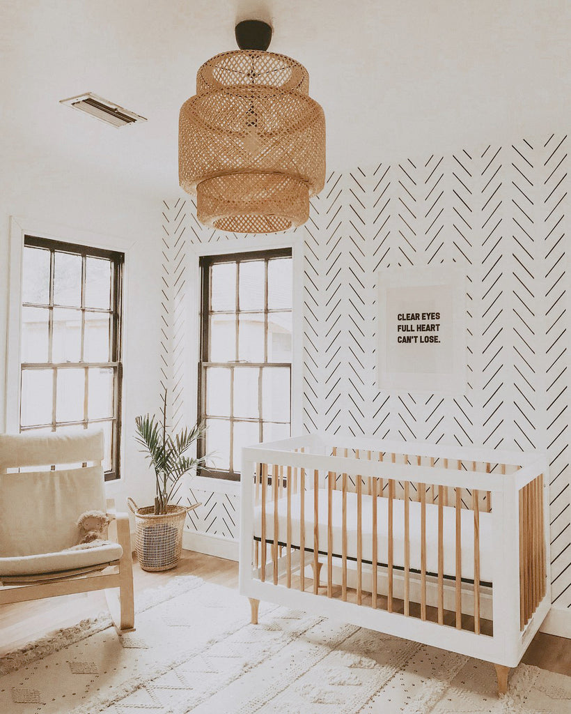 Minimal boho nursery with herringbone removable wallpaper