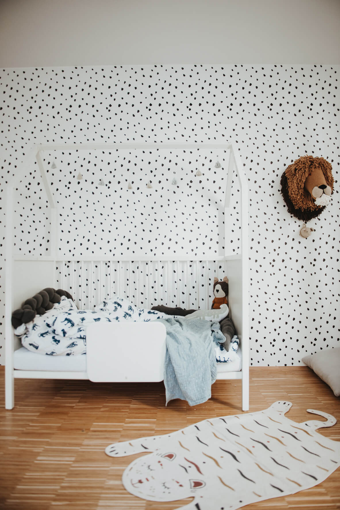 Eclectic dots removable wallpaper in minimal boys room interior