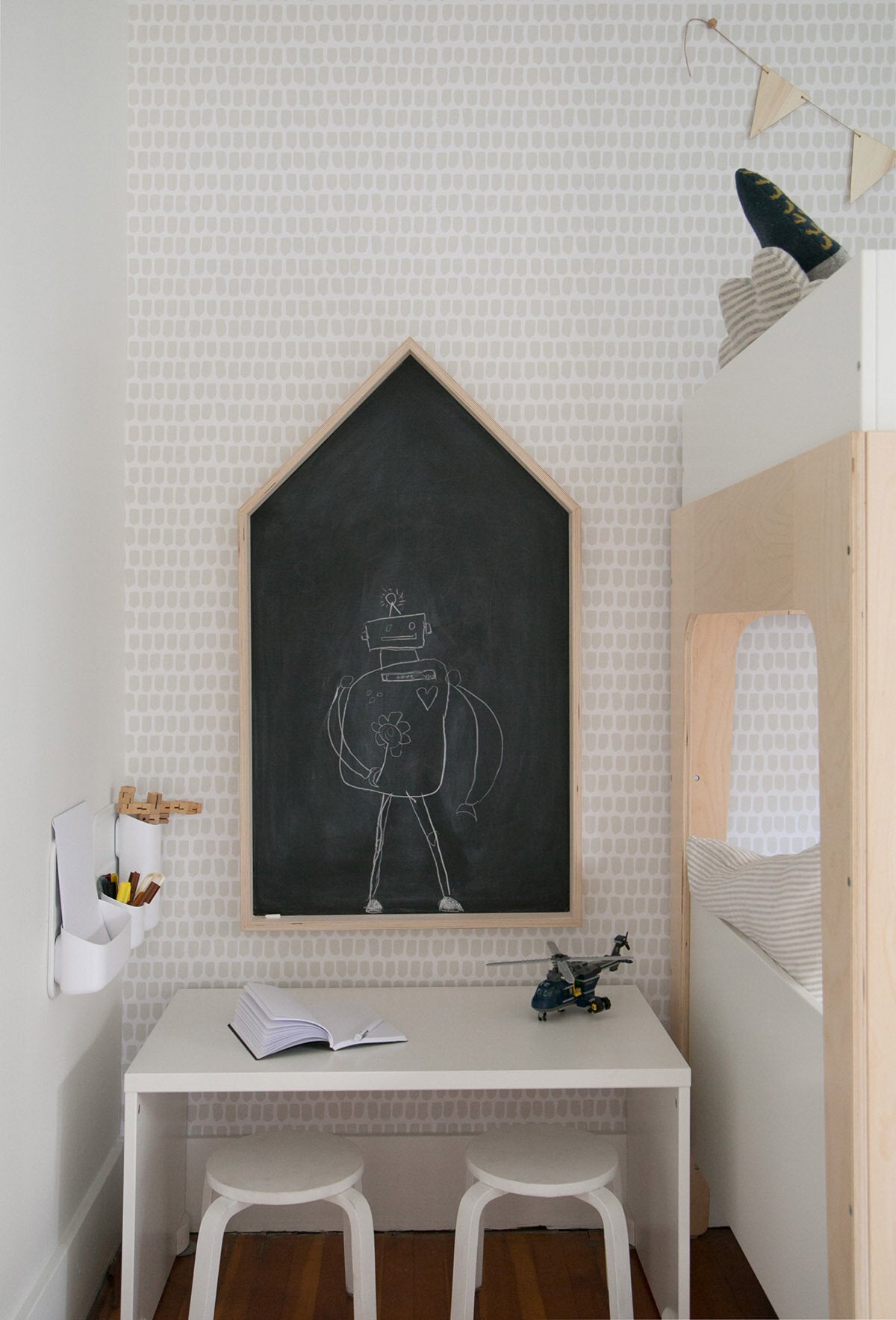 Modern boys room art corner with house shaped chalkboard wall, removable wallpaper and robot theme
