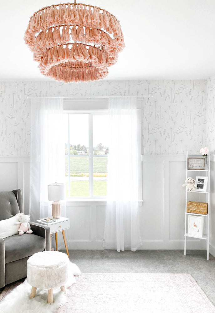 Modern white and pink nursery interior styled with delicate wildflower removable wallpaper