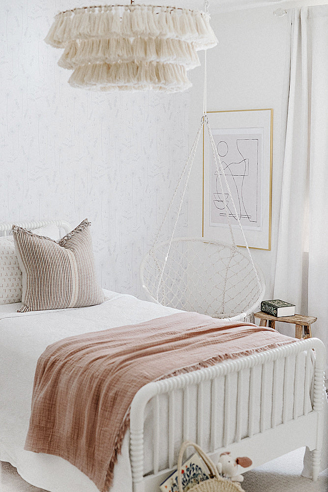 Beautiful bohemian girls bedroom interior with white an blush pink color scheme and wildflower design removable wallpaper