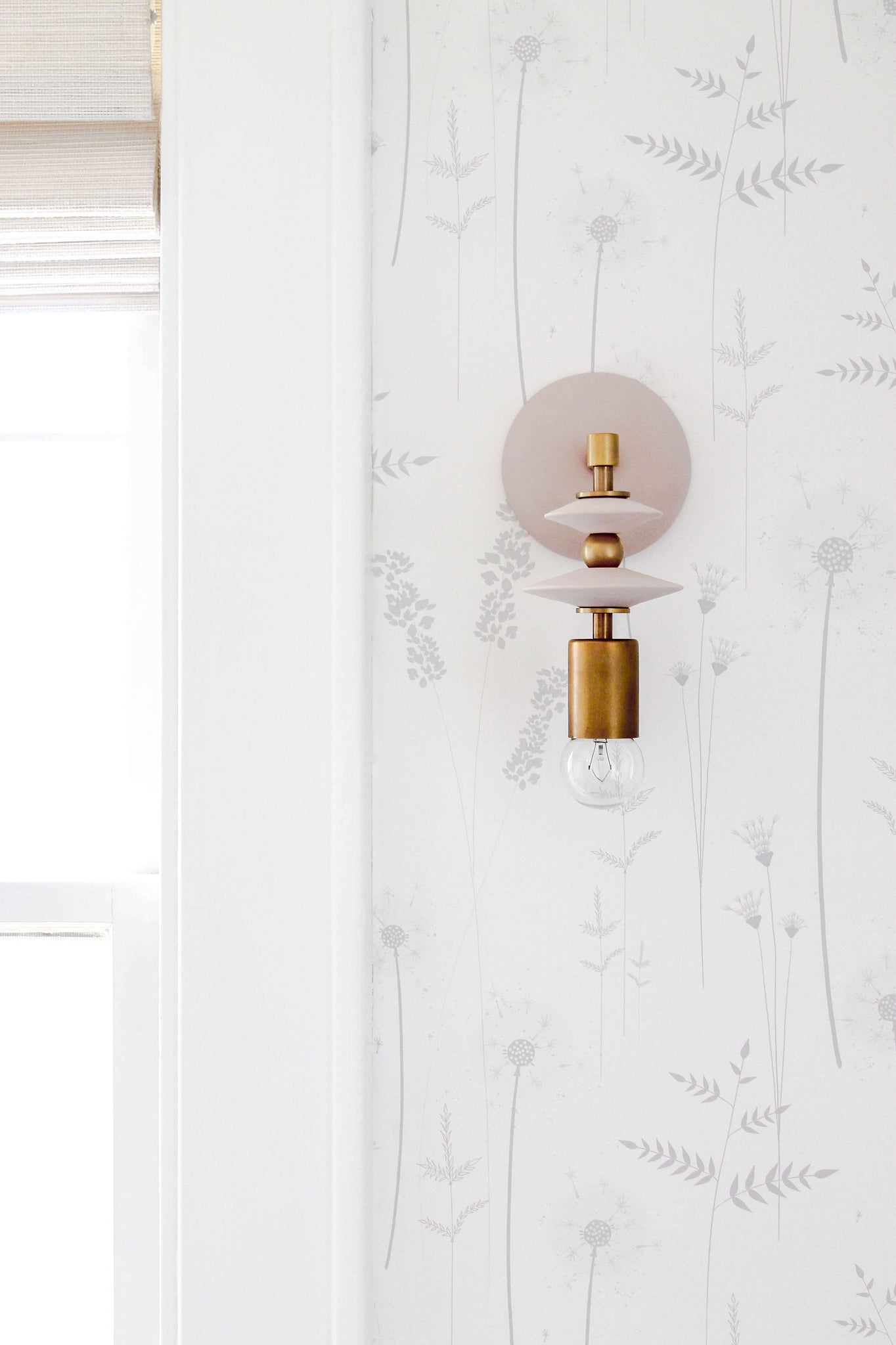 Modern geometric mid century wall sconces with blush pink and brass colors