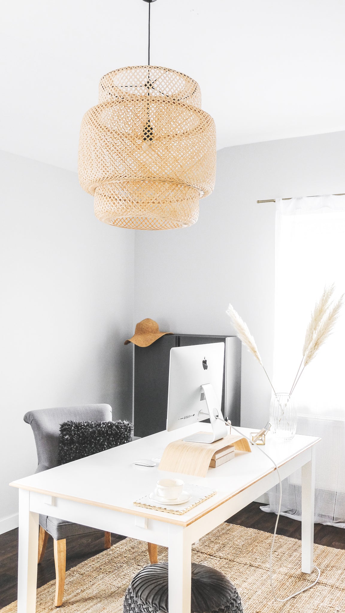 Boho chic office with white desk, gold and marble accents, and pampas grass floral arrangement