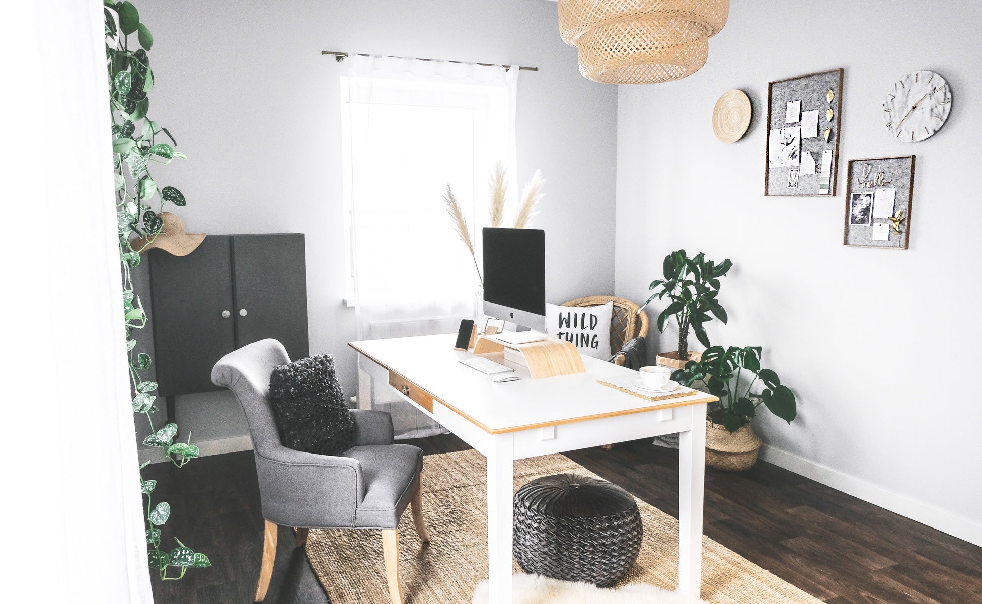 Minimalist bohemian office interior with grey color palette and gold accents