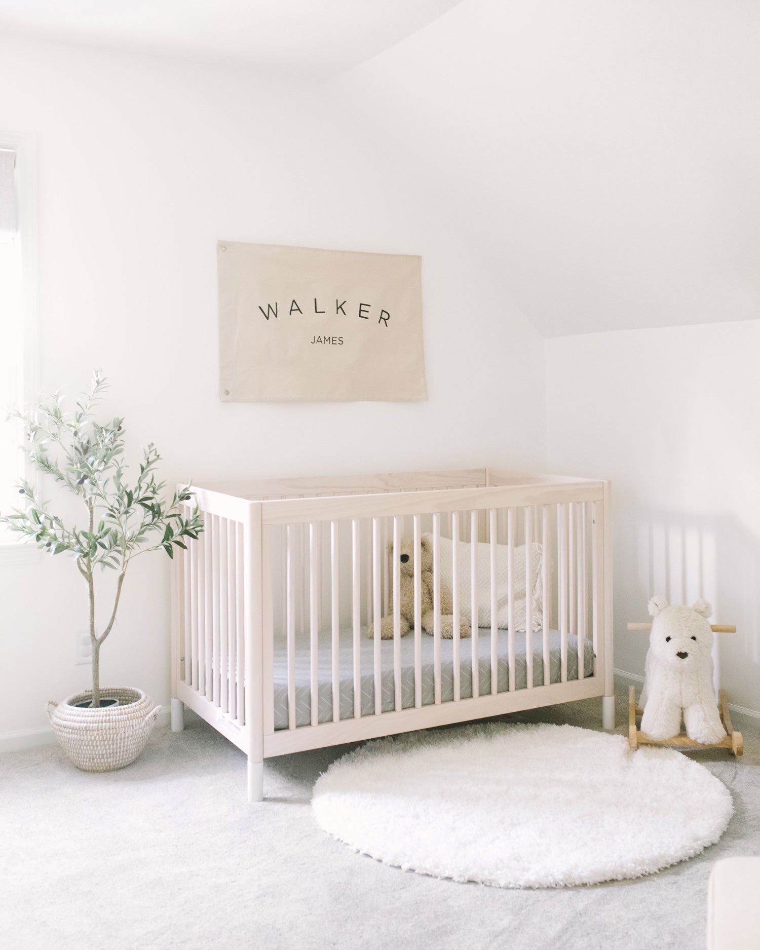 Minimal boho nursery interior design for baby boy with white and green color palette