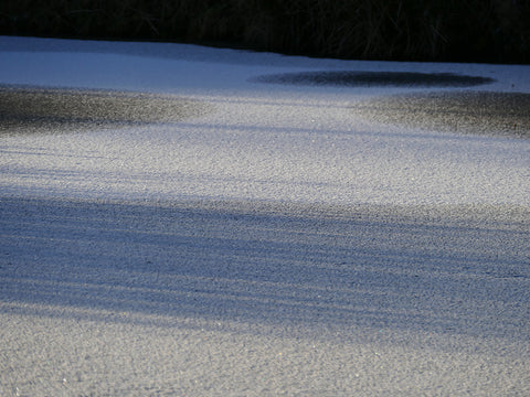 snowy Scottish pond with ice