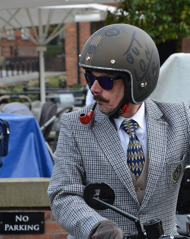 Distinguished gentlemans rider smoking a pipe