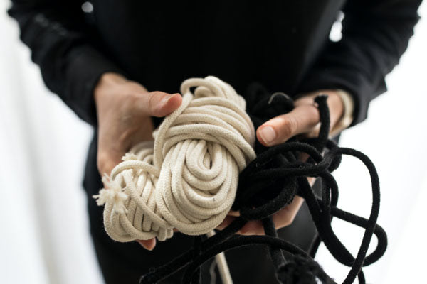 Mia Melange creates cotton home décor products. Image of sustainably farmed cotton rope held in hands. Mia Melange products available at Sarza home goods and furniture store in Rye New York. 