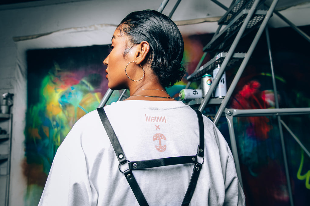 Female model wearing white tee, showing her back with back collab lockertag.