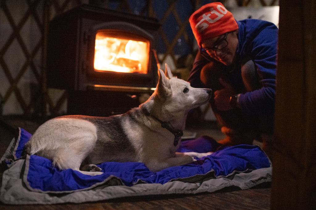Tala and Cade snuggle by the fire.