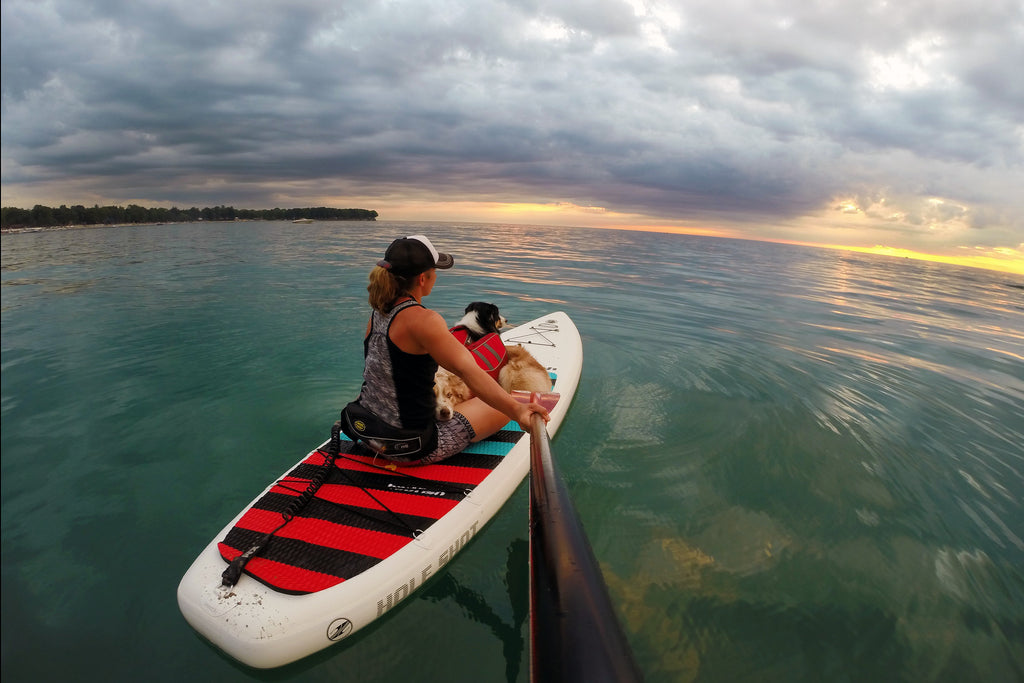 After a full day of swimming, paddling, and hot dog eating, Maria, Riley, and Kona watching the sunset from their own private island. 