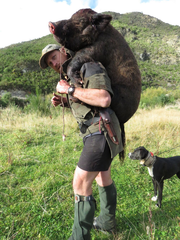 Shaun Monk carrying a pig