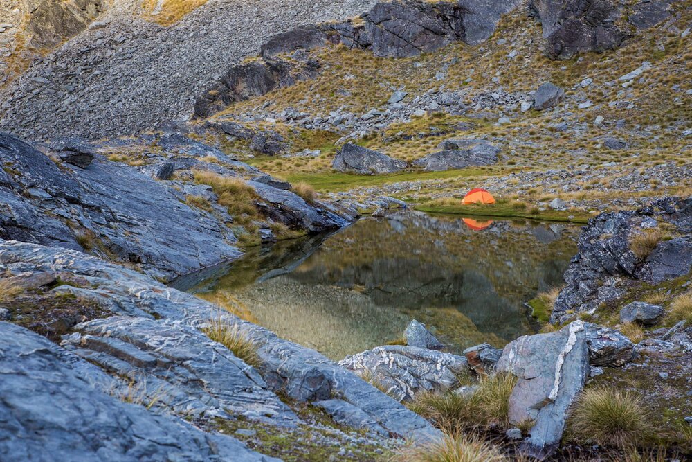 Alpine camping by a tarn