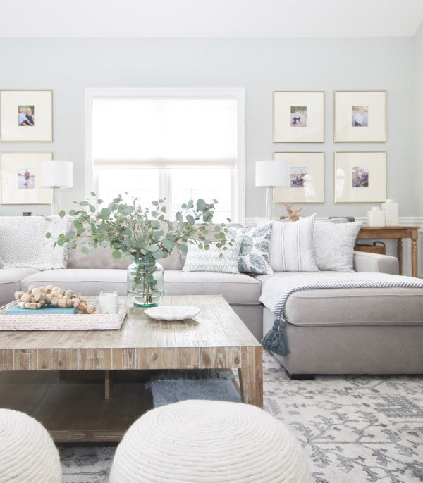 living room with comfy grey sectional sofa with mix of blue pillows in different patterns | interior design by Jess Weeth | Arianna Belle Blog
