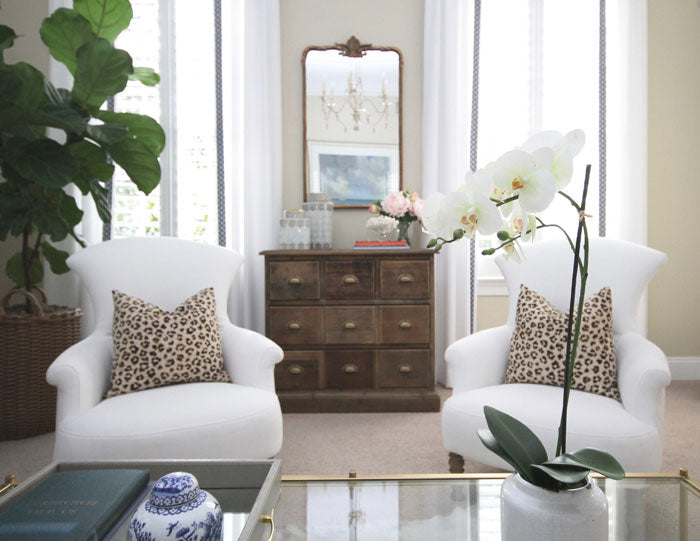 white chairs with arianna belle leopard linen designer pillows | interior design by Jess Weeth