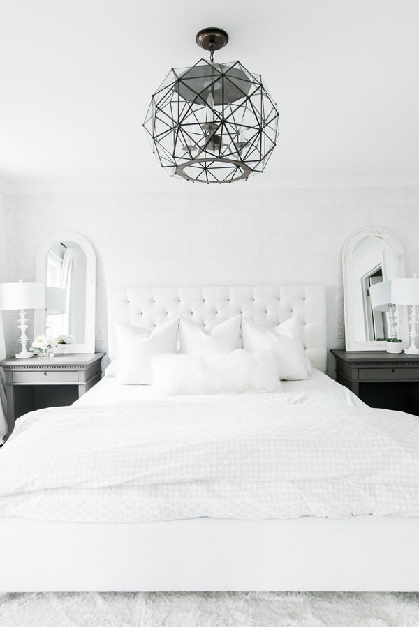 Designer Spotlight Kate + Amanda | Arianna Belle Blog | white and black modern glamorous bedroom white tufted headboard and unique ceiling fixture