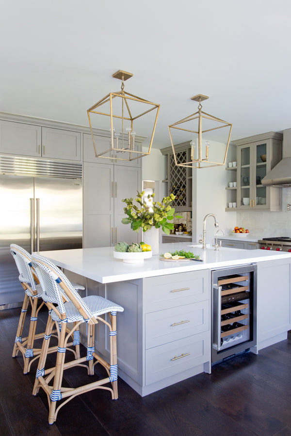Designer Spotlight: Jenn Feldman | grey kitchen with white counters french bistro chair stools brass fixtures 