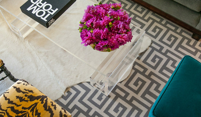 living room details - greek key rug, tiger print chair, lucite coffee table | interior design by Grant K. Gibson