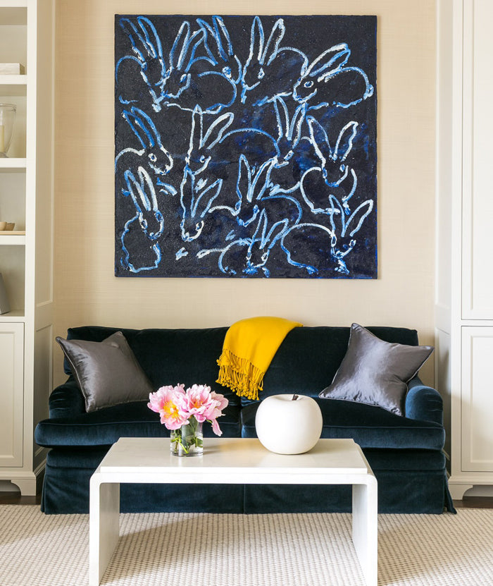 large Hunt Slonem painting artwork in living room with navy sofa and luxury pillows | interior design by Grant K. Gibson