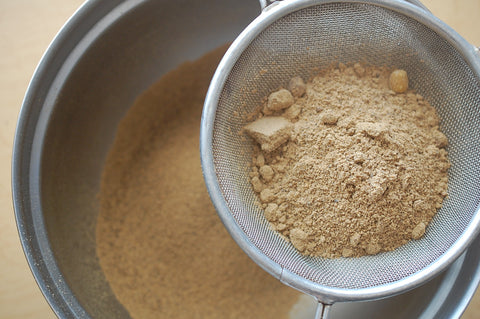 Sifting ground acorn flour