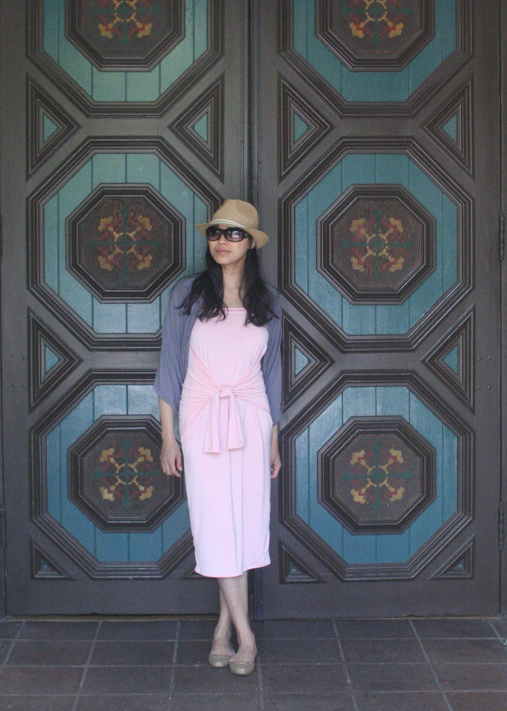  5 mothers day outfit ideas for any occasion: woman wearing a pink Henkaa convertible dress, sunglasses, a cardigan, and a summer hat.