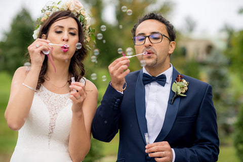 Henkaa A Bride's Story: Diana & Jas. Bride and groom blowing bubbles on wedding day. Flower crown.