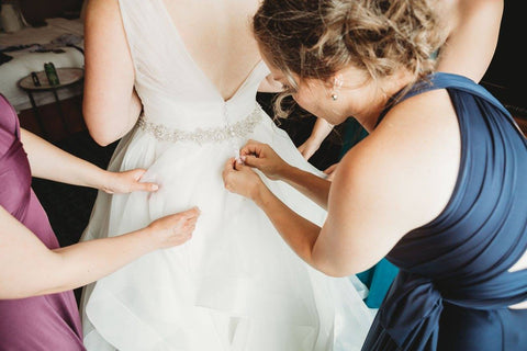 Jacqueline Sbeyti gets her dress donw up by her bridesmaids who are wearing Henkaa Sakura Convertible Dresses in Plum Purple, Navy Blue and Turquoise Teal.