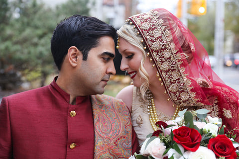 Stephanie Rochefort and Subhir Uppal gaze into each others eyes in traditional Hindu Wedding attire.