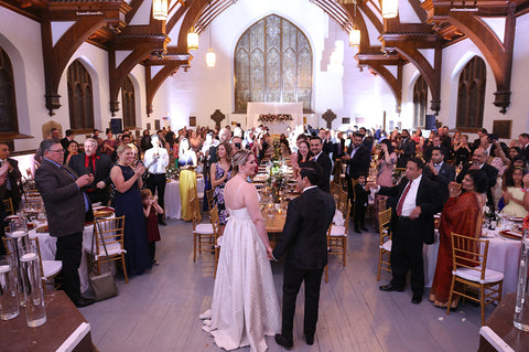 Stephanie Rochefort and Subhir Uppal hold hands as they greet their guests at their multicultural wedding reception at allsaints Event Space in Ottawa Ontario, Canada.
