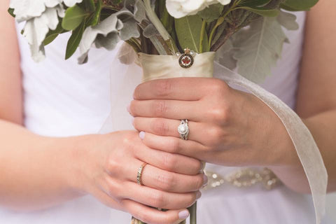 Hailey Judges honours her late father on her wedding day by attaching his police pin to her bouquet.