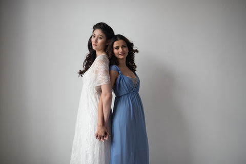 Two models wearing Henkaa Daffodil Convertible Dresses one in the Lace Daffodil Convertible Dress and the other in the Dusty Blue Daffodil Chiffon Convertible Dress