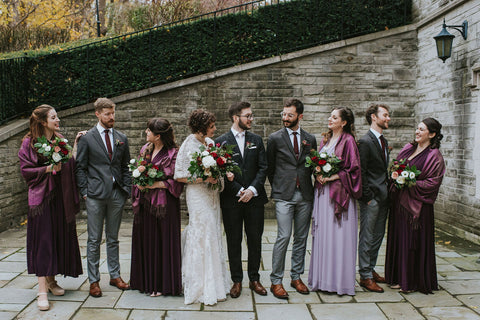 Averie and Bled pose with their wedding party. Bridesmaids are wearing Henkaa Eggplant Purple and Dusty Purple Sakura Maxi Convertible Dresses perfect for fall weddings.