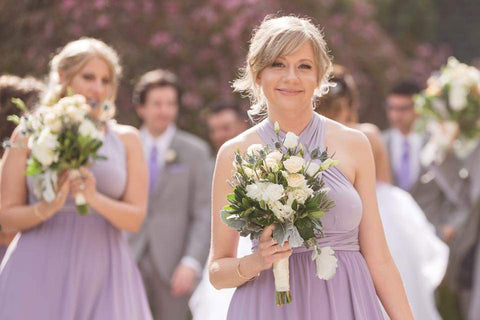 Henkaa Dusty Purple Sakura Maxi Convertible Dresses worn on bridesmaids. Bridesmaids carrying white rose bouquets.