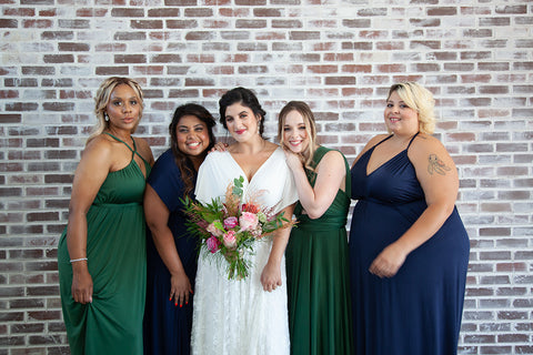 2020 Wedding Trend Report: Henkaa Ivy and Sakura convertible bridesmaid dresses in Navy Blue and Hunter Green Bride is wearing the Sakura Lace Convertible Wedding Dress.