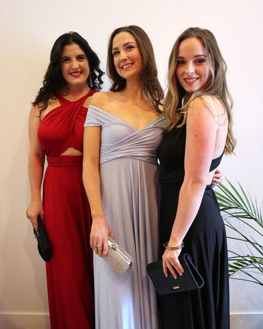 3 girls pose at Prom in Henkaa Sakura Maxi convertible dress holding clutches.